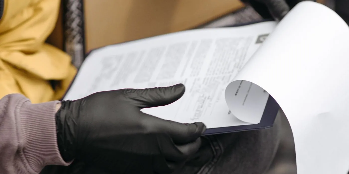 Delivery worker reviewing documents on a clipboard
