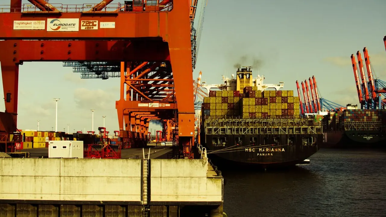 Container vessel and loading cranes at a port