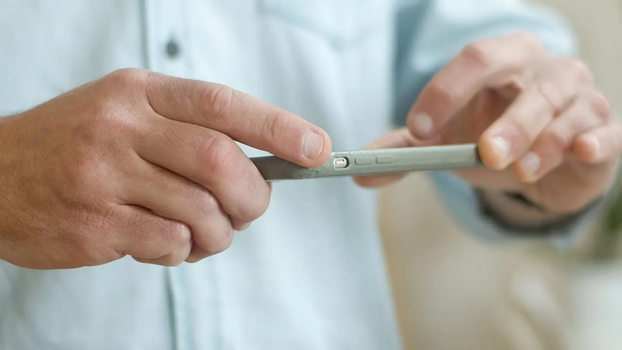Person photographing a package with a smartphone