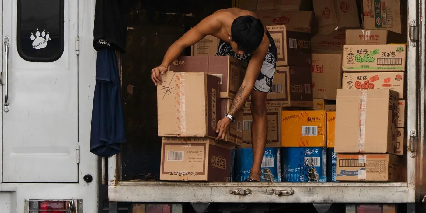 Delivery worker organizing boxes inside a truck