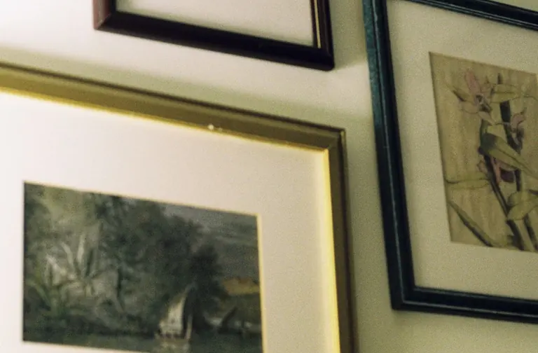 Framed artworks hanging on a wall