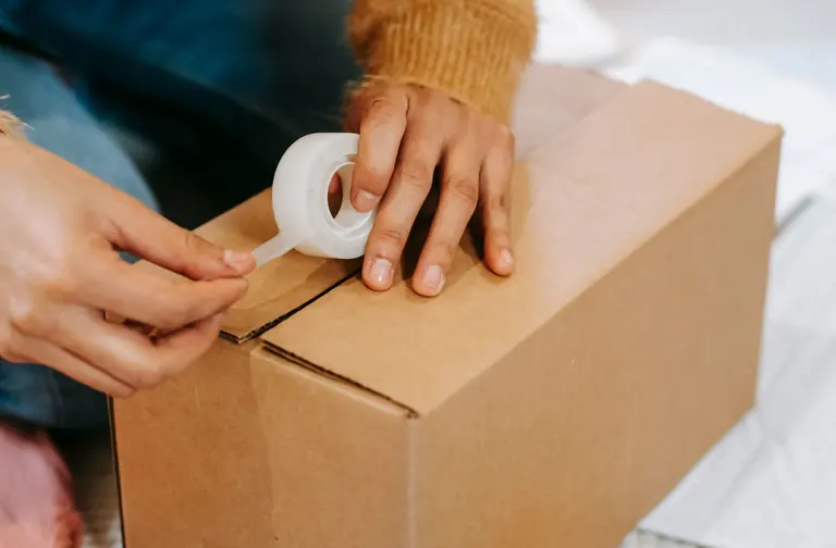 Preparing a parcel with adhesive tape