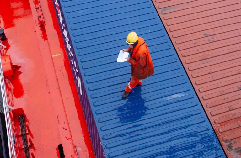 Worker checking container loading