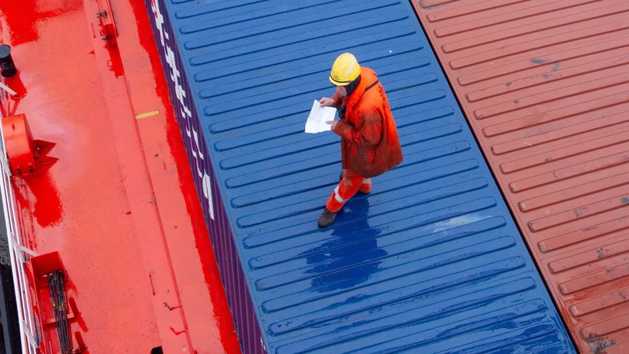 Worker checking container loading