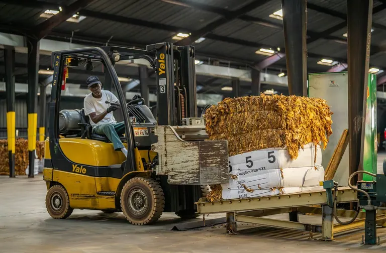 Forklift transporting packaged materials on a pallet
