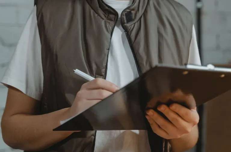 Employee checking inventory with a clipboard