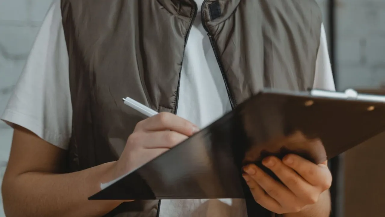 Employee checking inventory with a clipboard