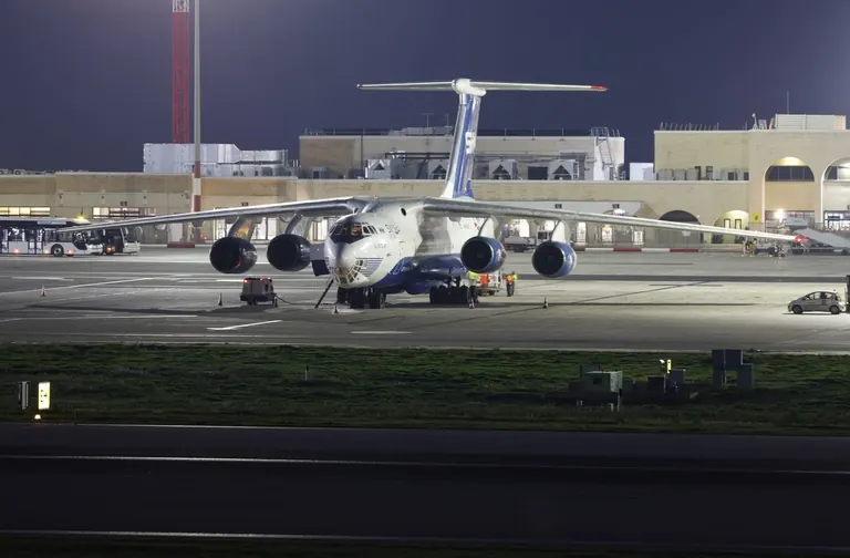 Cargo aircraft at an airport at night