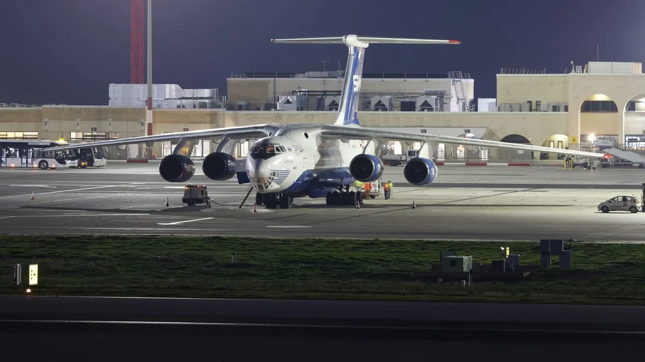 Cargo aircraft at an airport at night