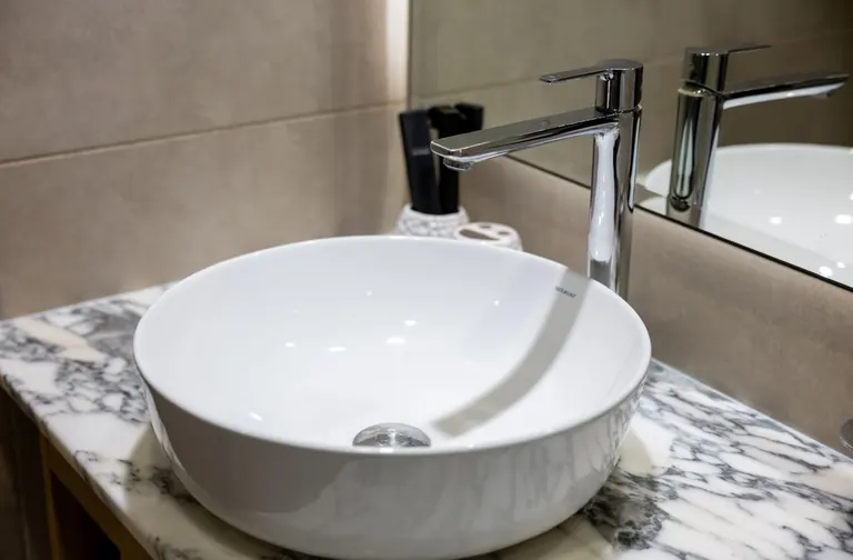 Bathroom basin with a chrome faucet