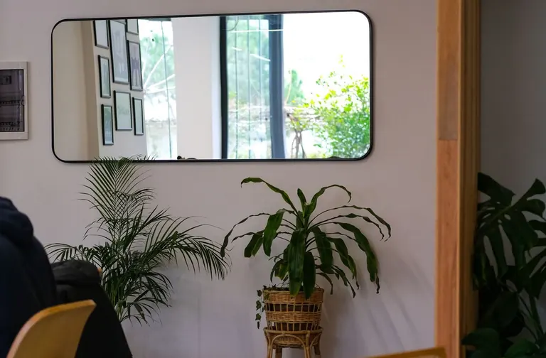 Wall mirror reflecting an interior