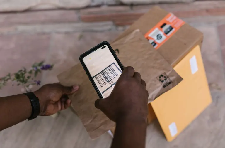Courier scanning a parcel barcode