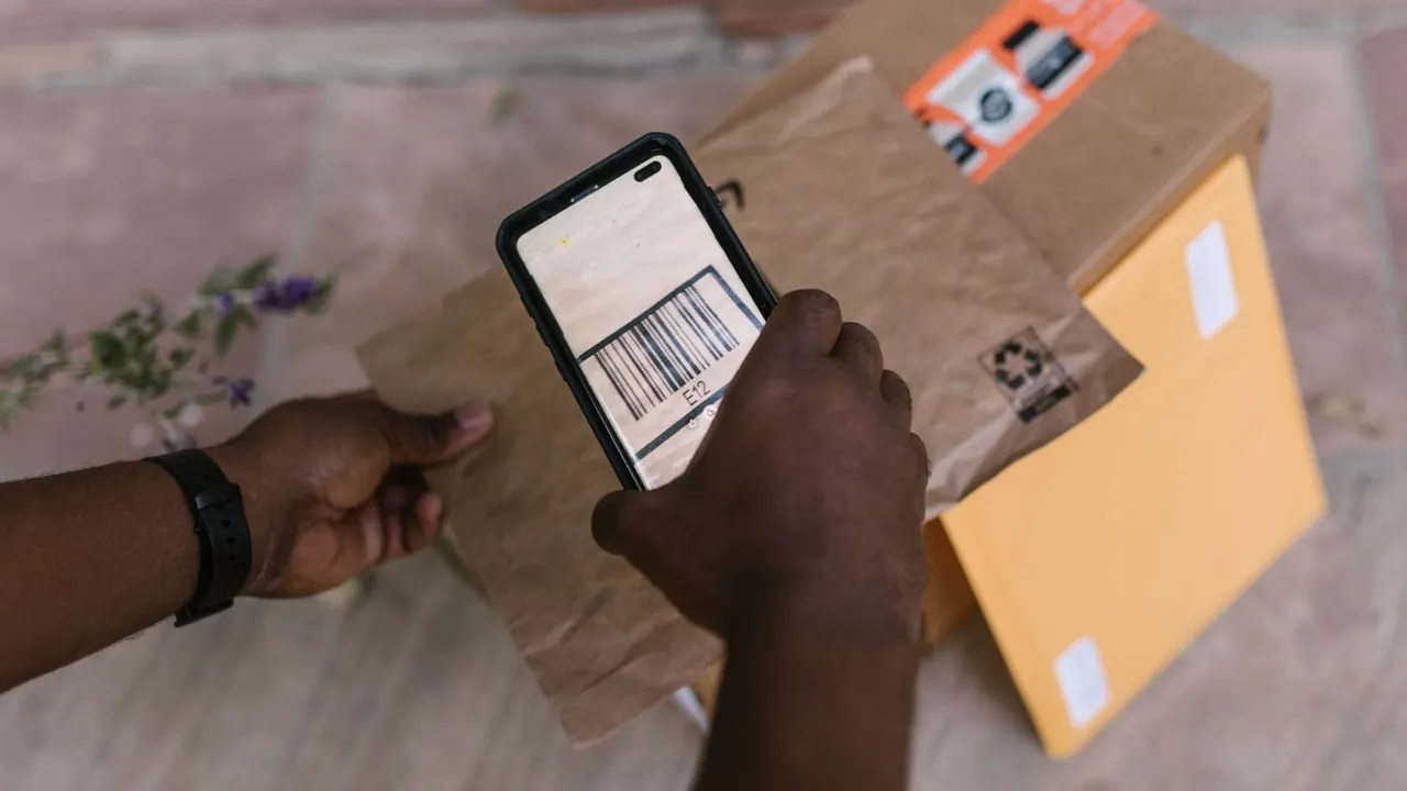 Courier scanning a parcel barcode