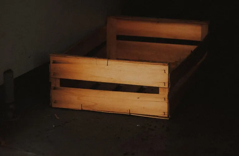 An empty wooden crate on a floor