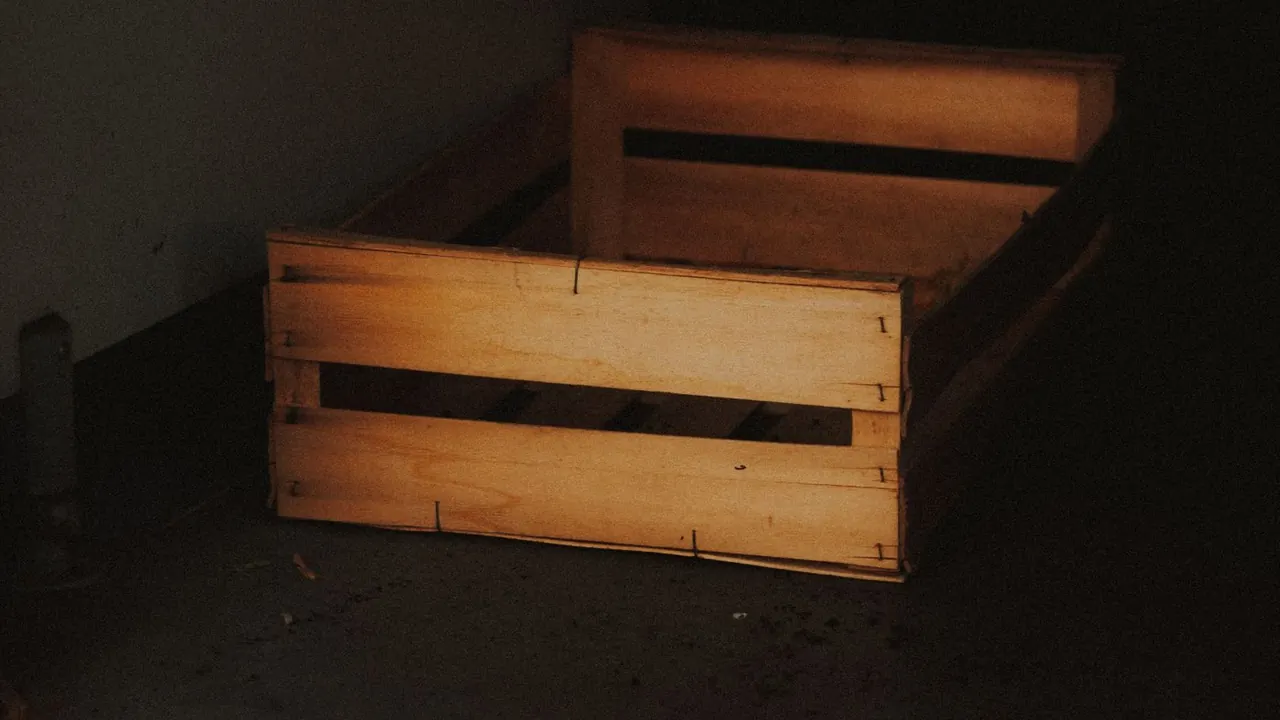 An empty wooden crate on a floor